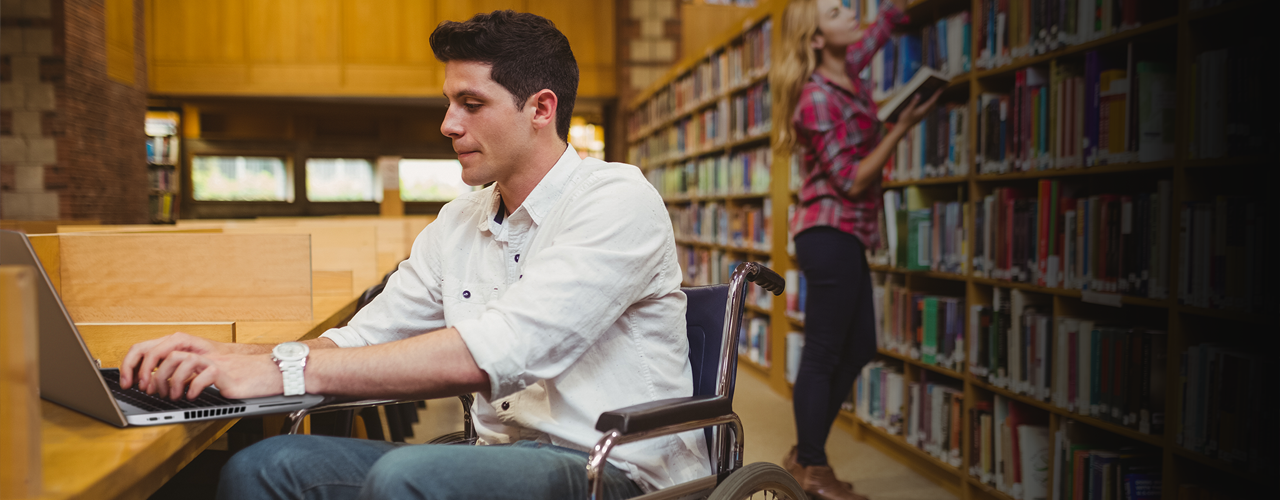 man on laptop in library